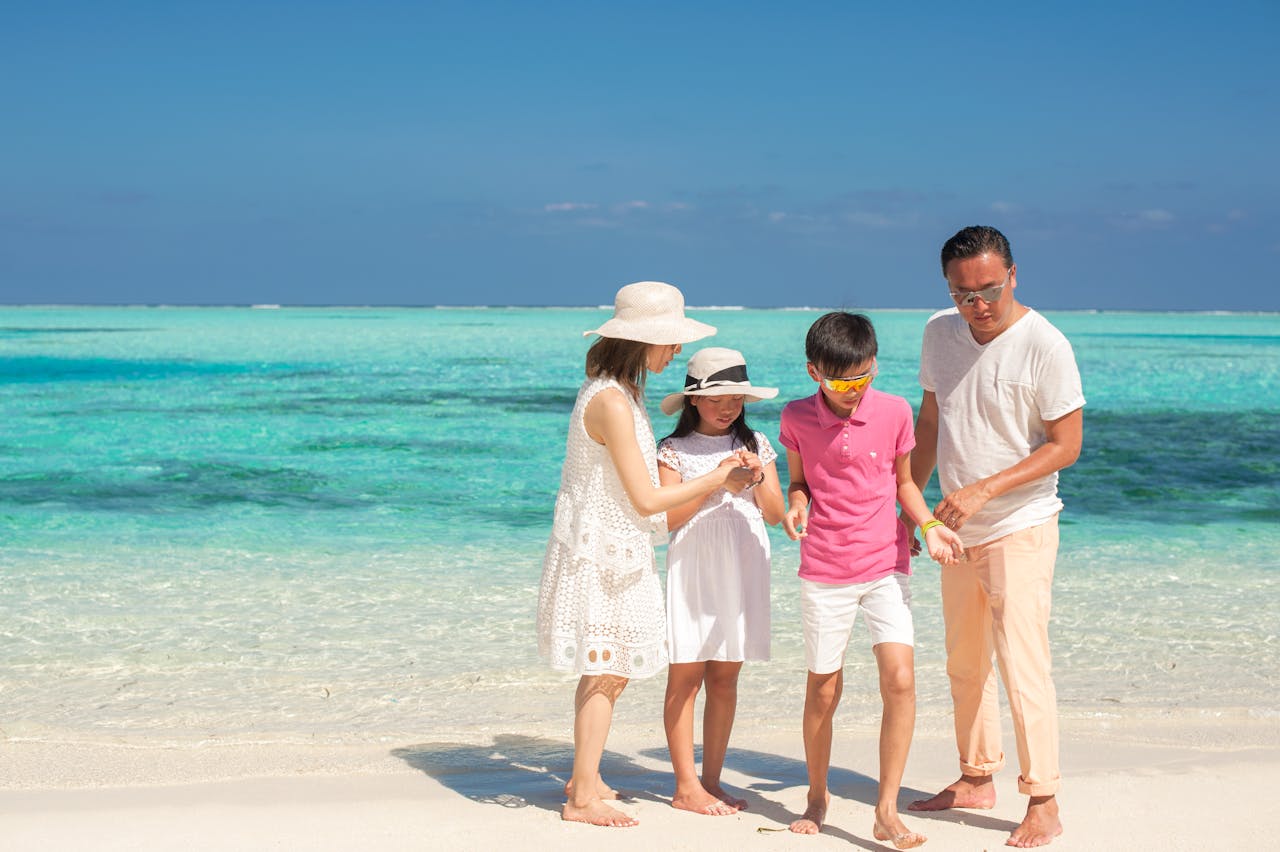 Happy family bonding on a sunny beach, capturing fun moments during summer vacation.